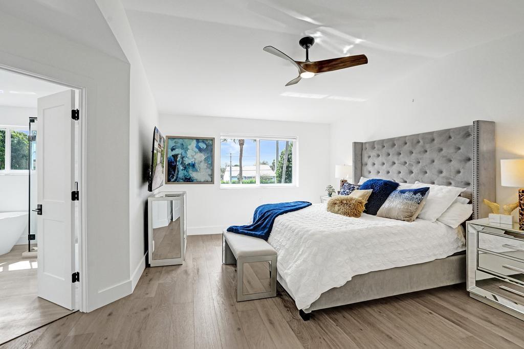 6800 Via Regina Boca Raton, FL 33433 - Photo 24 of 58 a bedroom with a bed and wooden floor