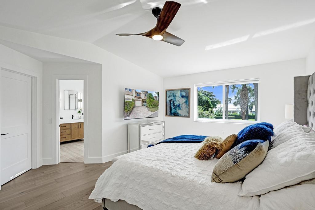 6800 Via Regina Boca Raton, FL 33433 - Photo 25 of 58 a bedroom with a bed and a large window