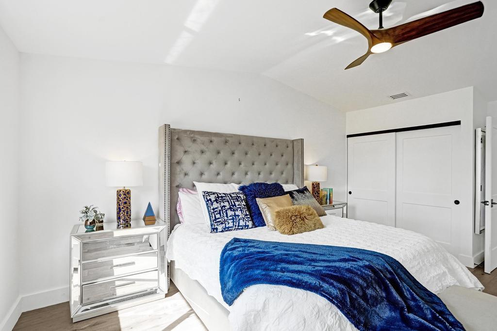 6800 Via Regina Boca Raton, FL 33433 - Photo 26 of 58 a bedroom with a bed and ceiling fan