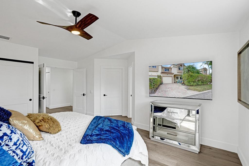 6800 Via Regina Boca Raton, FL 33433 - Photo 27 of 58 a bedroom with a bed and a window