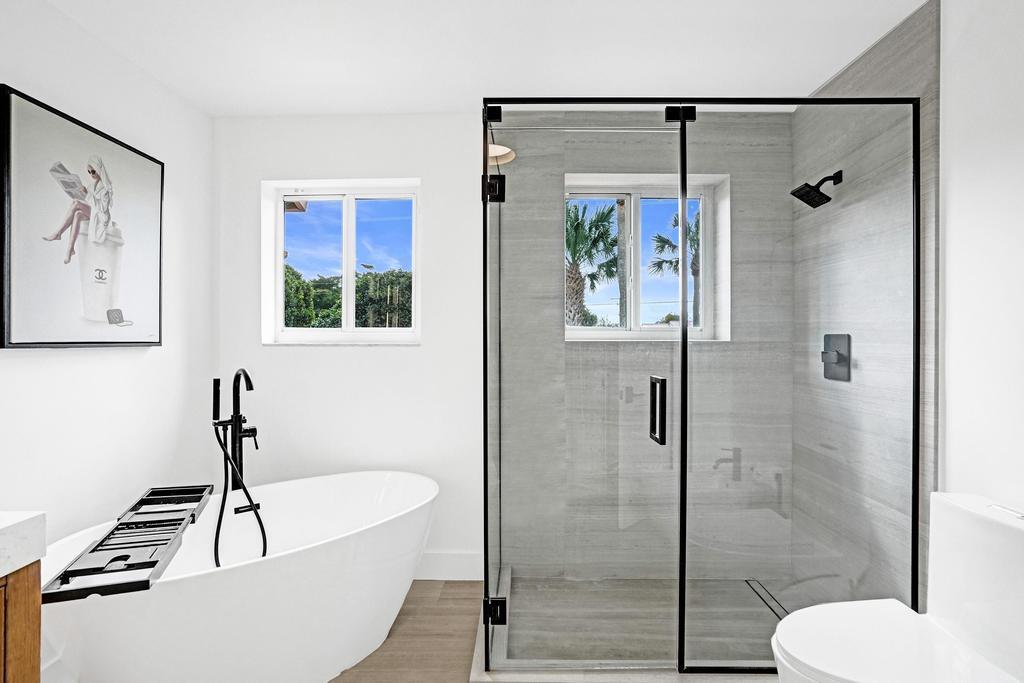 6800 Via Regina Boca Raton, FL 33433 - Photo 31 of 58 a bathroom with a sink a toilet and shower