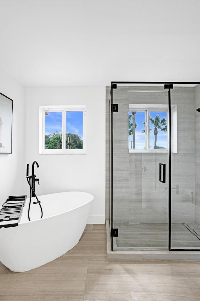 6800 Via Regina Boca Raton, FL 33433 - Photo 32 of 58 a white bath tub sitting next to a glass door