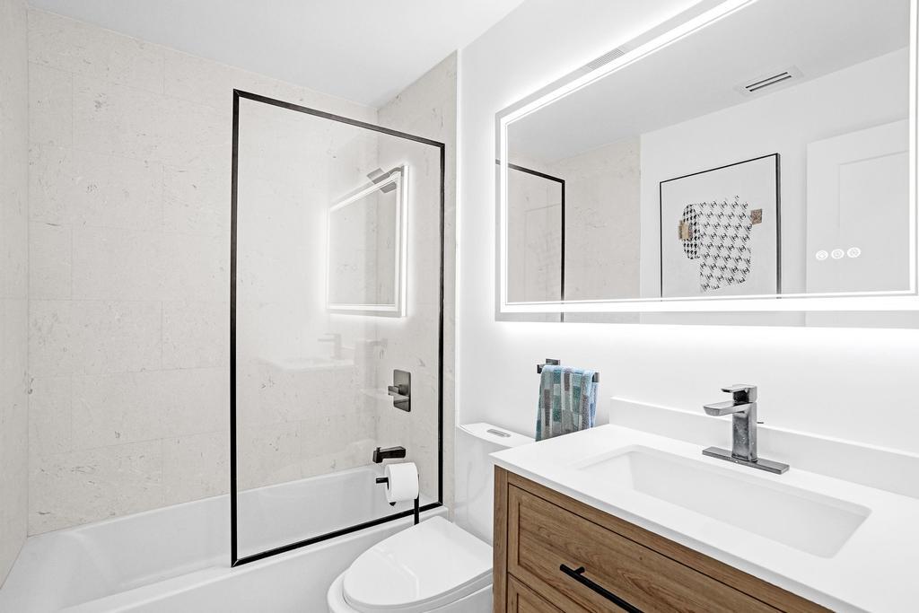 6800 Via Regina Boca Raton, FL 33433 - Photo 33 of 58 a bathroom with a sink a toilet and shower