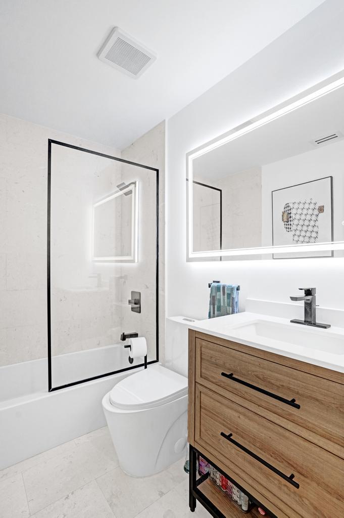 6800 Via Regina Boca Raton, FL 33433 - Photo 34 of 58 a bathroom with a sink a toilet and mirror