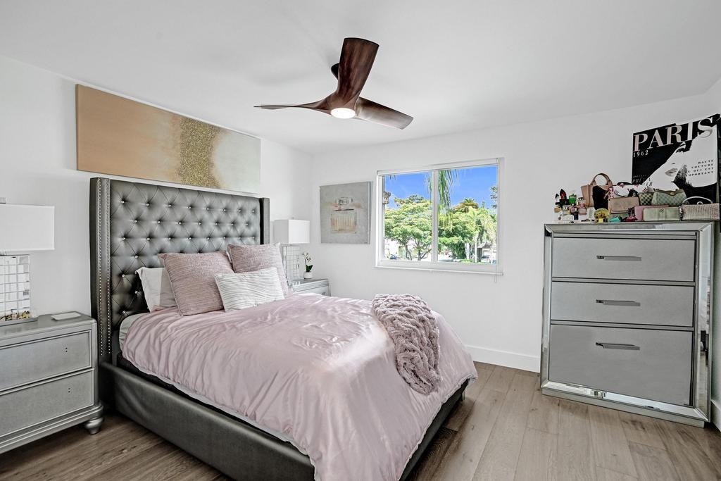 6800 Via Regina Boca Raton, FL 33433 - Photo 35 of 58 a bedroom with a bed and a dresser next to a window