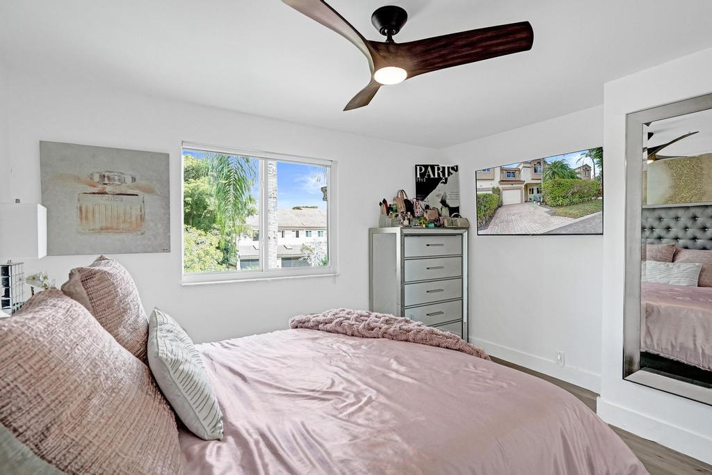 6800 Via Regina Boca Raton, FL 33433 - Photo 36 of 58 a bedroom with a bed dresser and a window