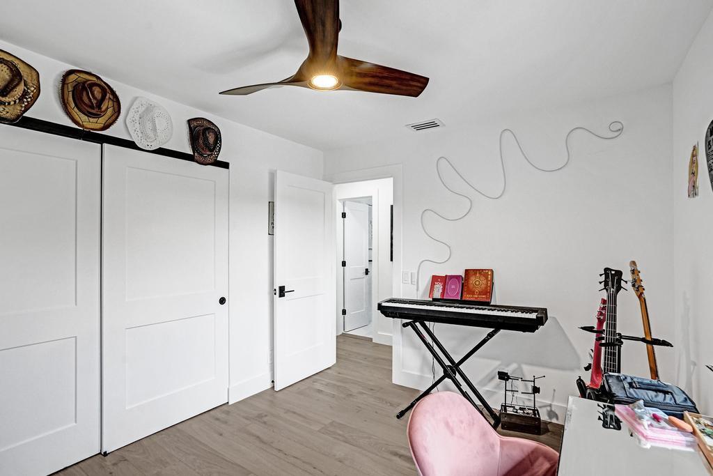 6800 Via Regina Boca Raton, FL 33433 - Photo 40 of 58 a room with gym equipment and wooden floor