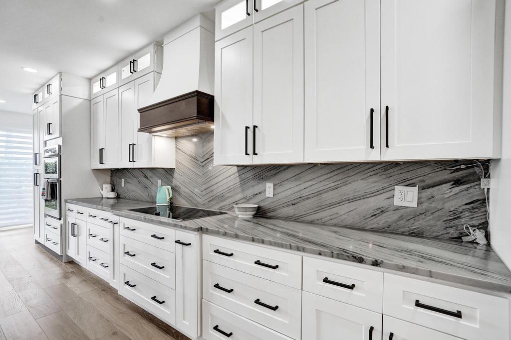 6800 Via Regina Boca Raton, FL 33433 - Photo 9 of 58 a kitchen with granite countertop cabinets and window