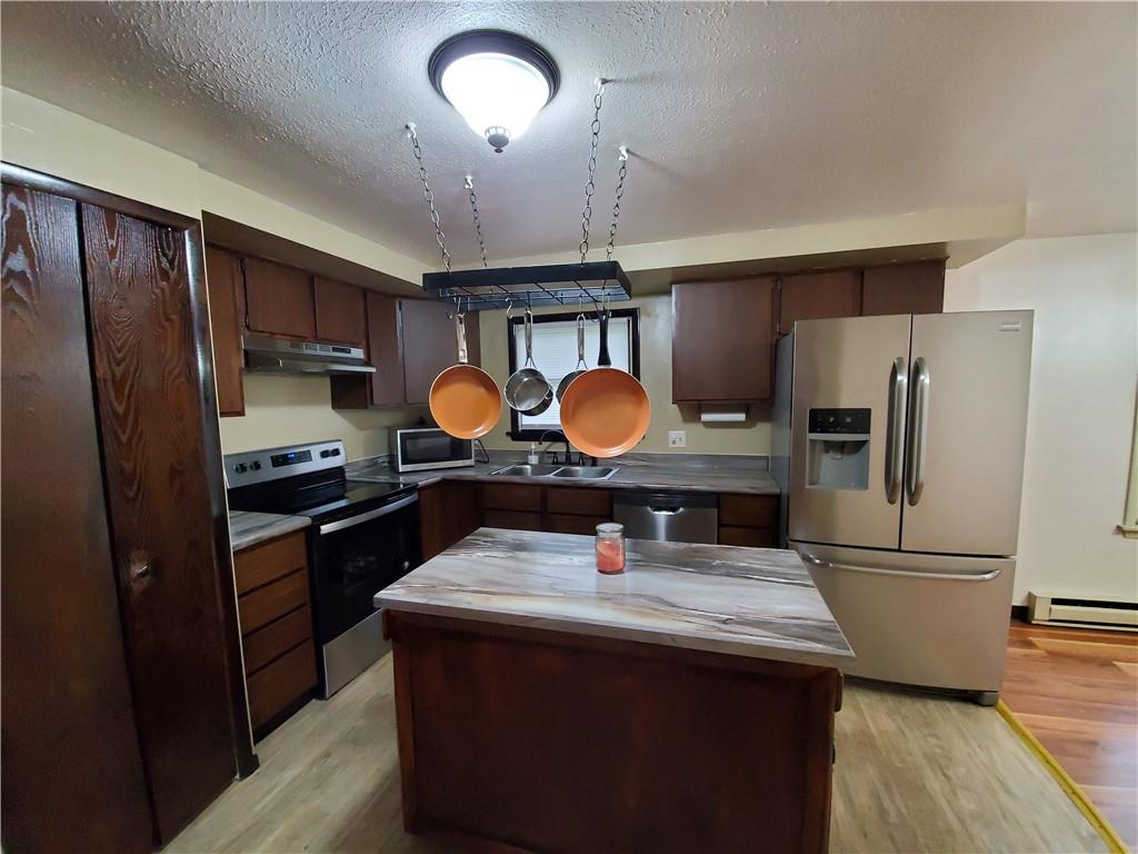 1502 County Line Road Champion, PA 15622 - Photo 8 of 22 a kitchen with stainless steel appliances granite countertop a refrigerator a stove and a sink