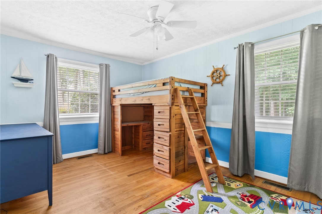 9400 Morley Road Midlothian, VA 23112 - Photo 22 of 38 Bedroom 3 with hardwood floors, crown moulding, an