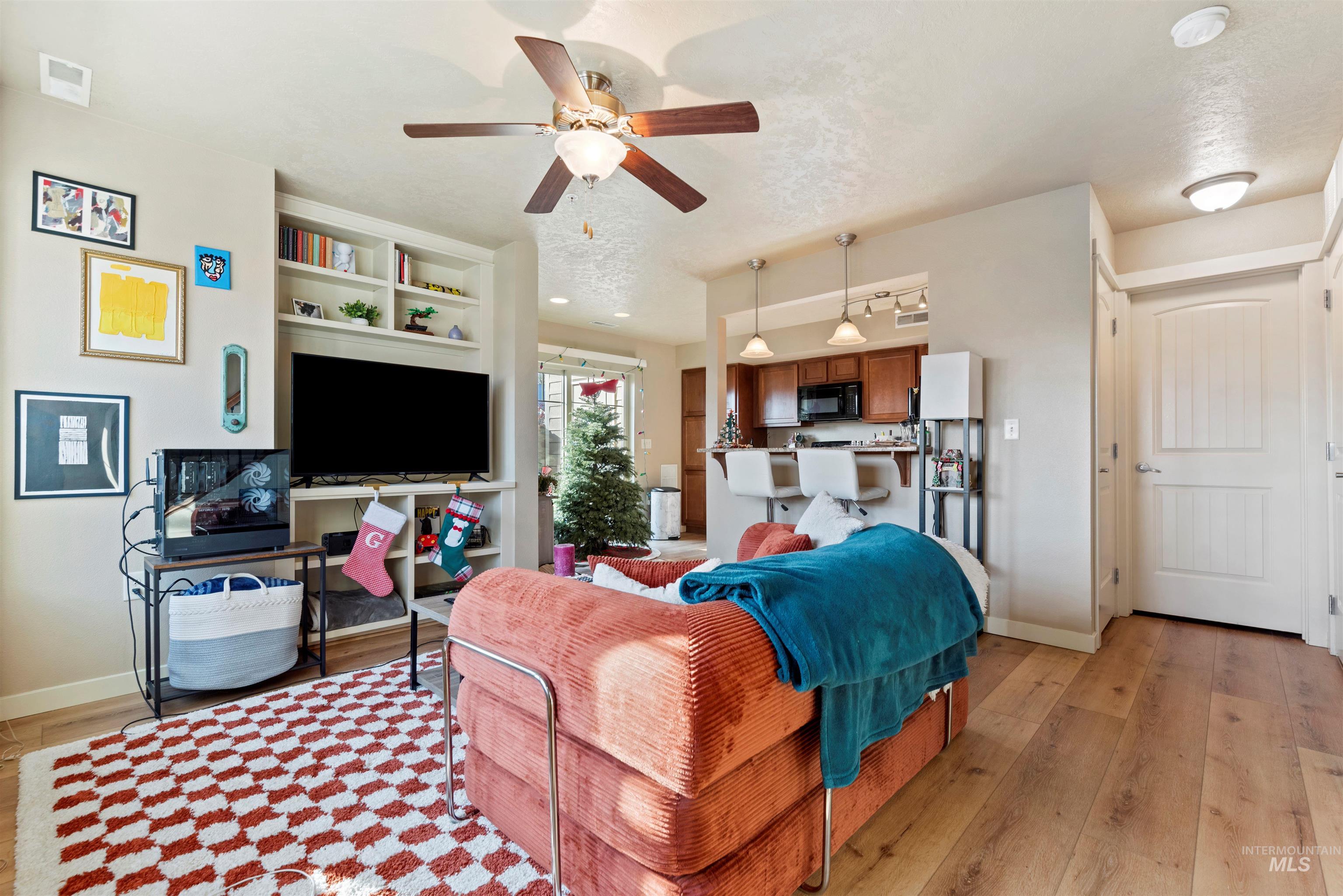 9107 Ustick Road Boise, ID 83704 - Photo 5 of 8 Living area with ceiling fan and light wood finished floors