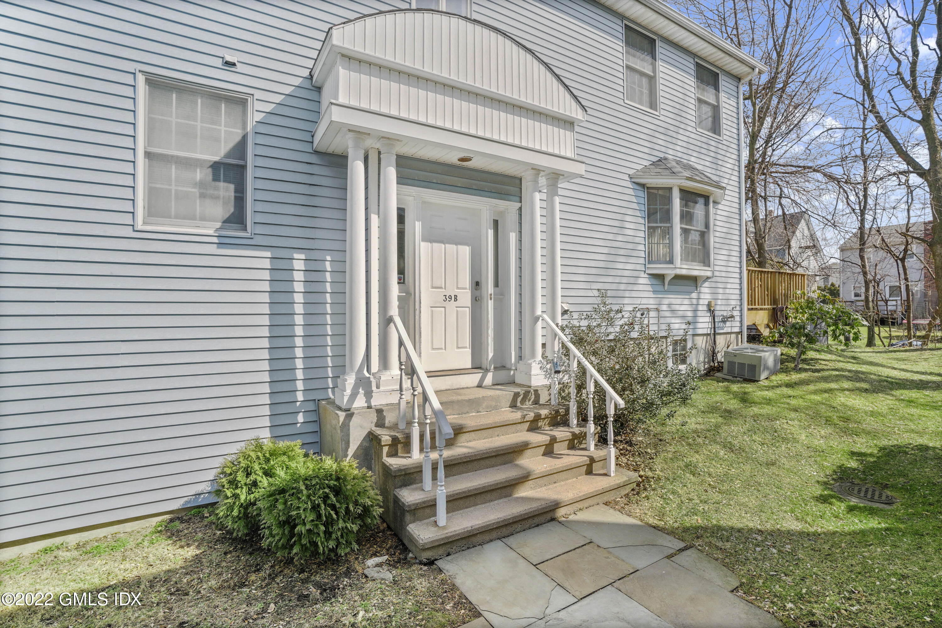 39 Alexander Street, Unit B Greenwich, CT 06830 - Photo 12 of 17 a front view of a house with a yard