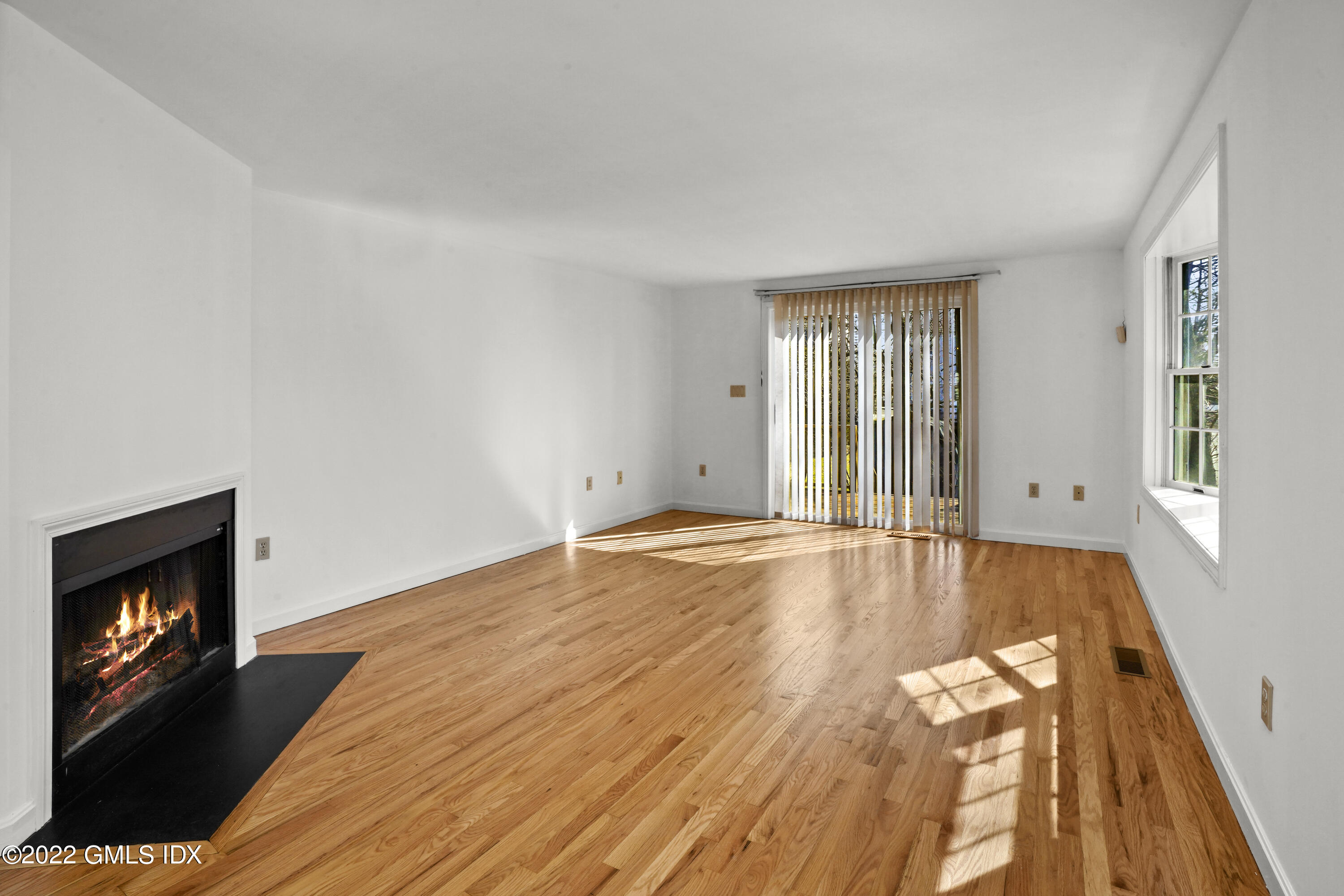 39 Alexander Street, Unit B Greenwich, CT 06830 - Photo 2 of 17 a view of an empty room with wooden floor and a window