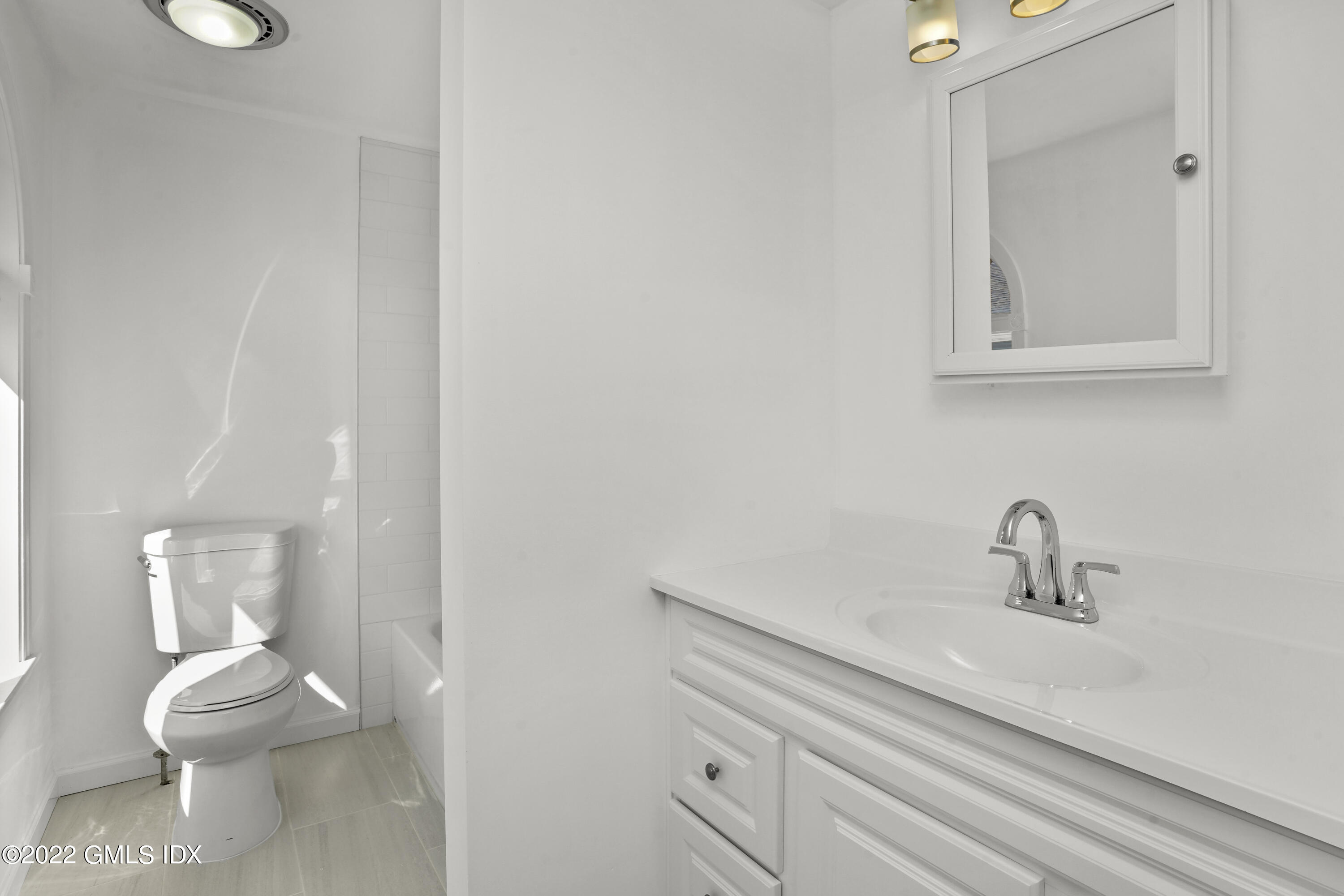39 Alexander Street, Unit B Greenwich, CT 06830 - Photo 8 of 17 a bathroom with a toilet sink and mirror