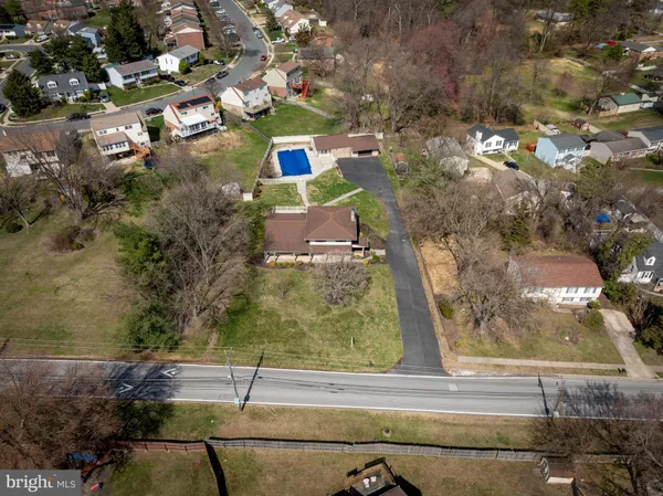an aerial view of a house with a swimming pool
