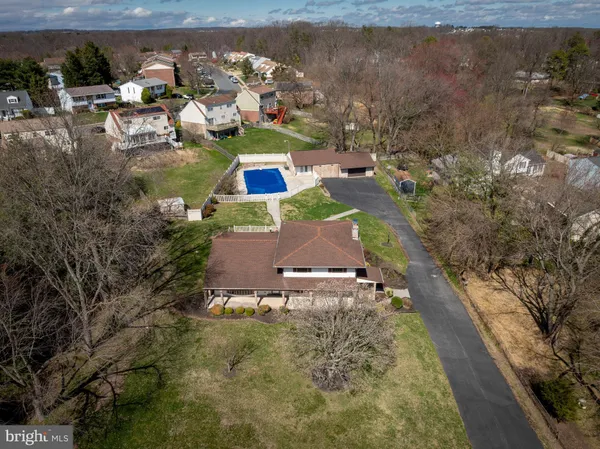 an aerial view of a house with a swimming pool