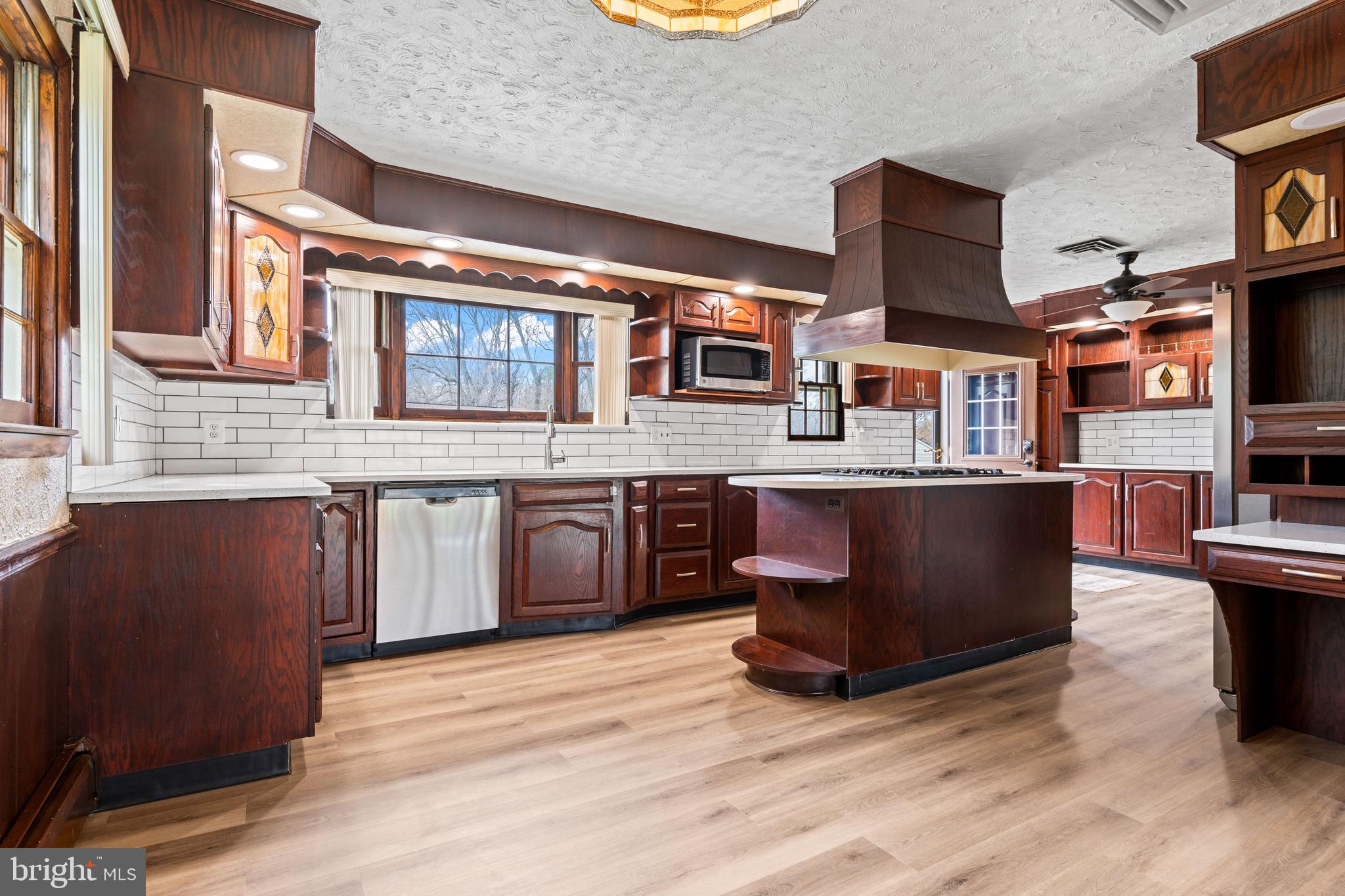 5030 Silver Spring Road Perry Hall, MD 21128 - Photo 33 of 97 a kitchen with stainless steel appliances granite countertop a sink and a wooden cabinets