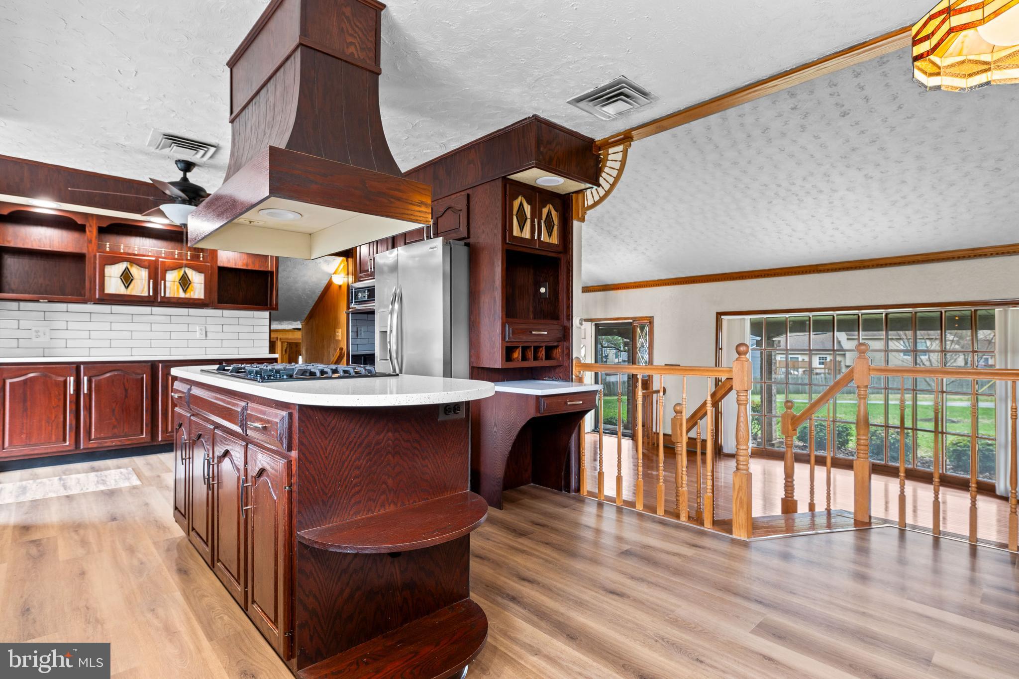 5030 Silver Spring Road Perry Hall, MD 21128 - Photo 35 of 97 a kitchen with stainless steel appliances granite countertop a stove a sink dishwasher and a dining table with wooden floor