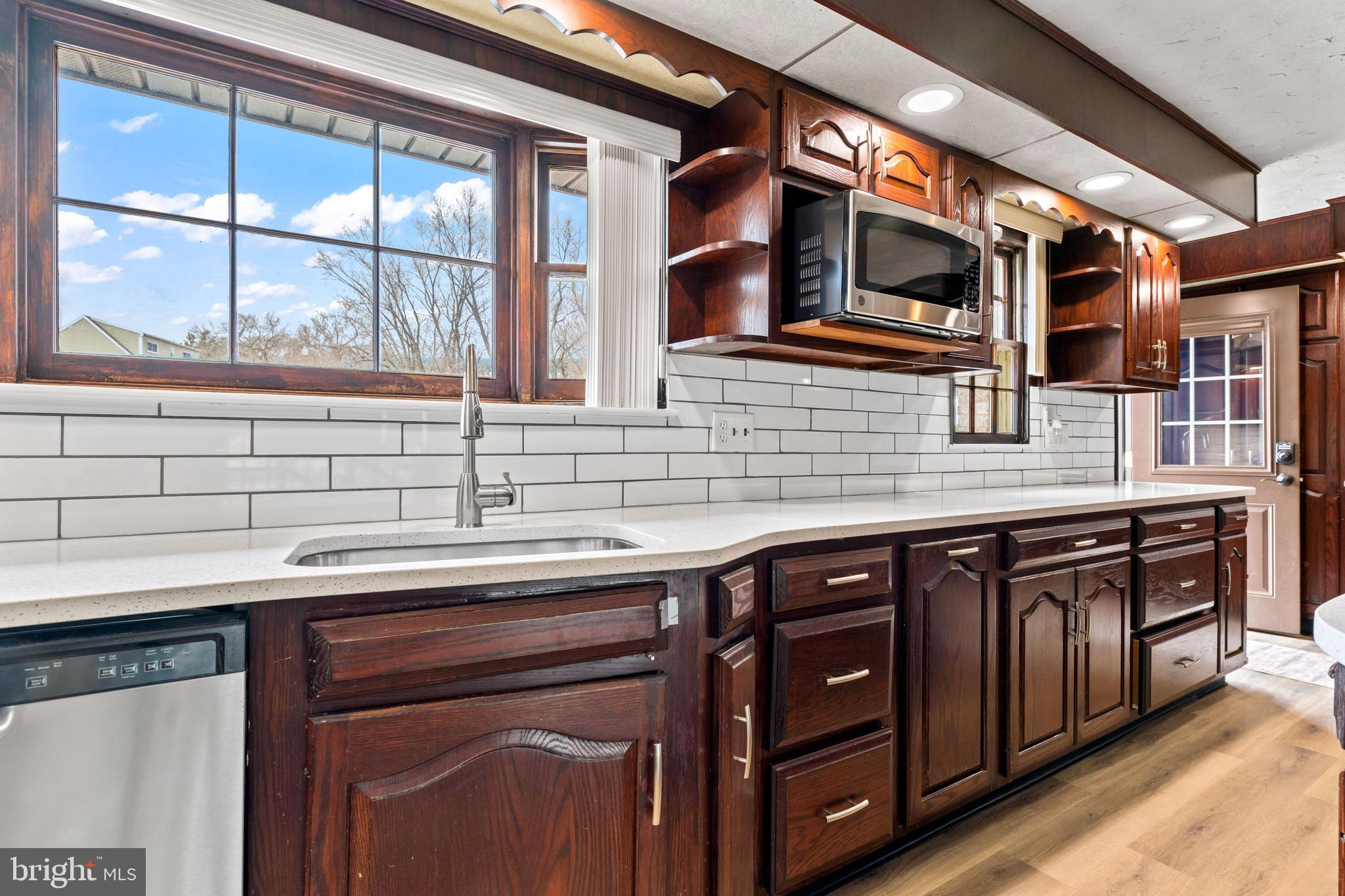 5030 Silver Spring Road Perry Hall, MD 21128 - Photo 36 of 97 a kitchen with stainless steel appliances granite countertop a sink and a microwave