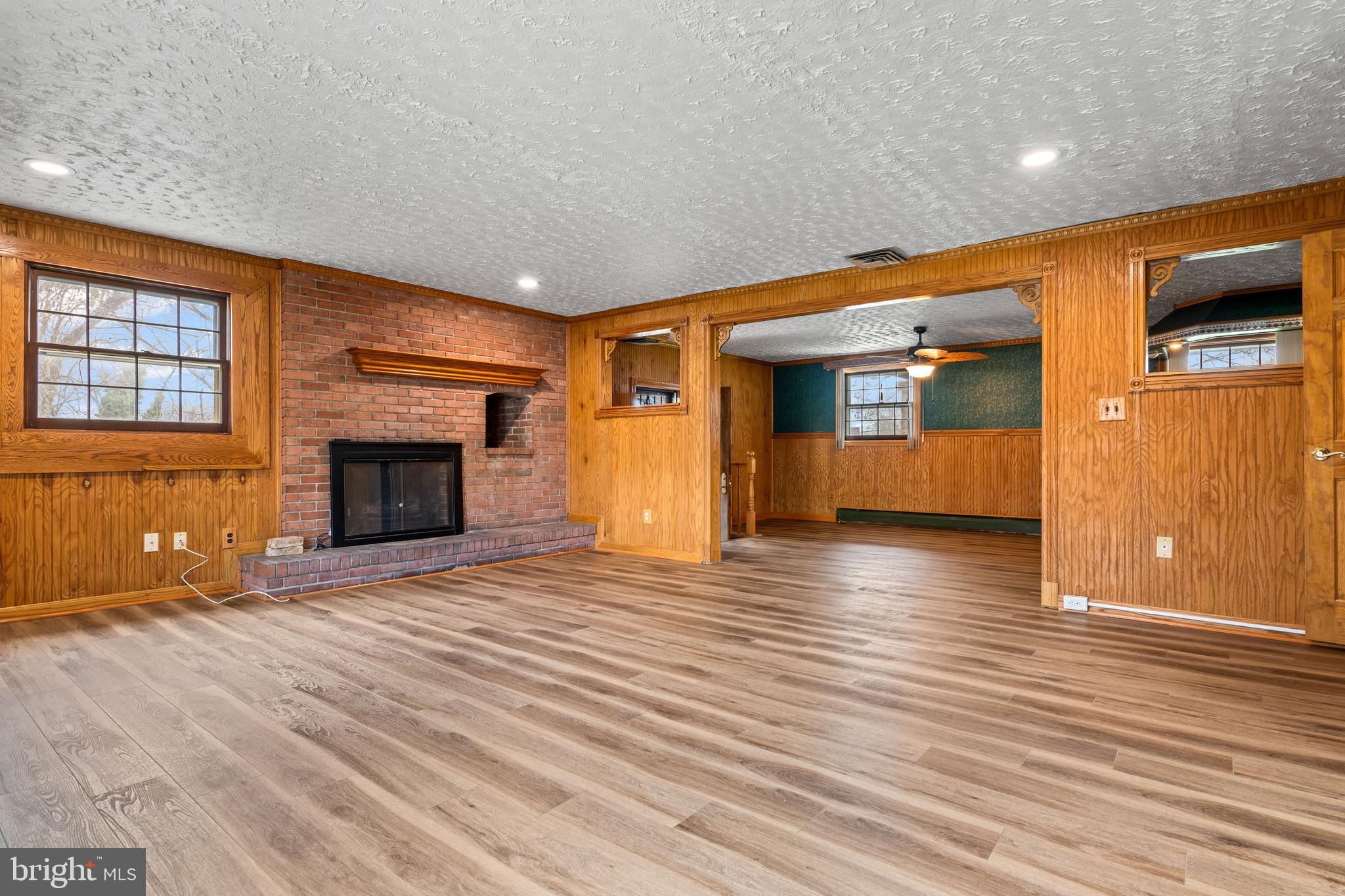 5030 Silver Spring Road Perry Hall, MD 21128 - Photo 57 of 97 a view of an empty room with wooden floor fireplace and a window