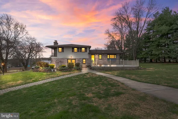 a front view of a building with a garden