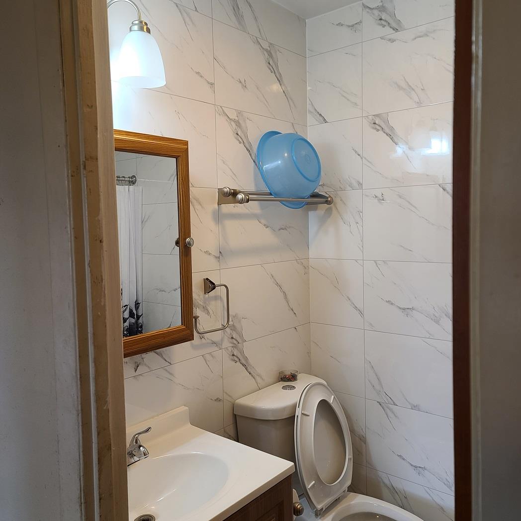 85-10 165th Street Queens, NY 11432 - Photo 13 of 24 a bathroom with a toilet and a shower