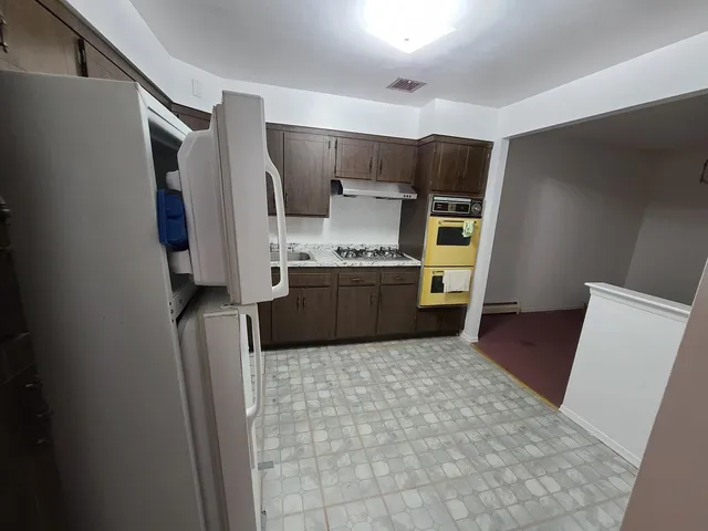 a kitchen with stainless steel appliances a refrigerator and a sink