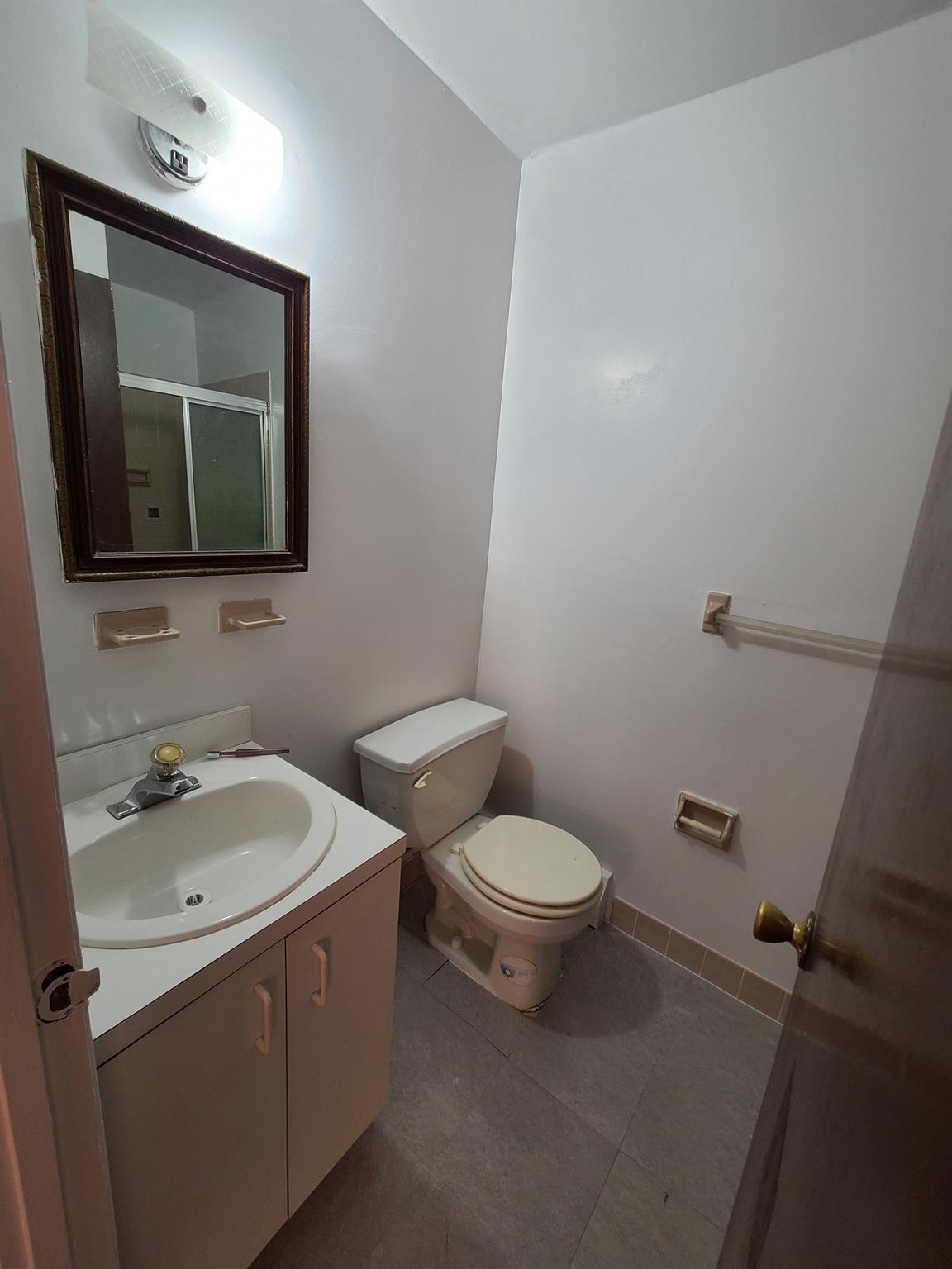 85-10 165th Street Queens, NY 11432 - Photo 17 of 24 a bathroom with a toilet sink and mirror