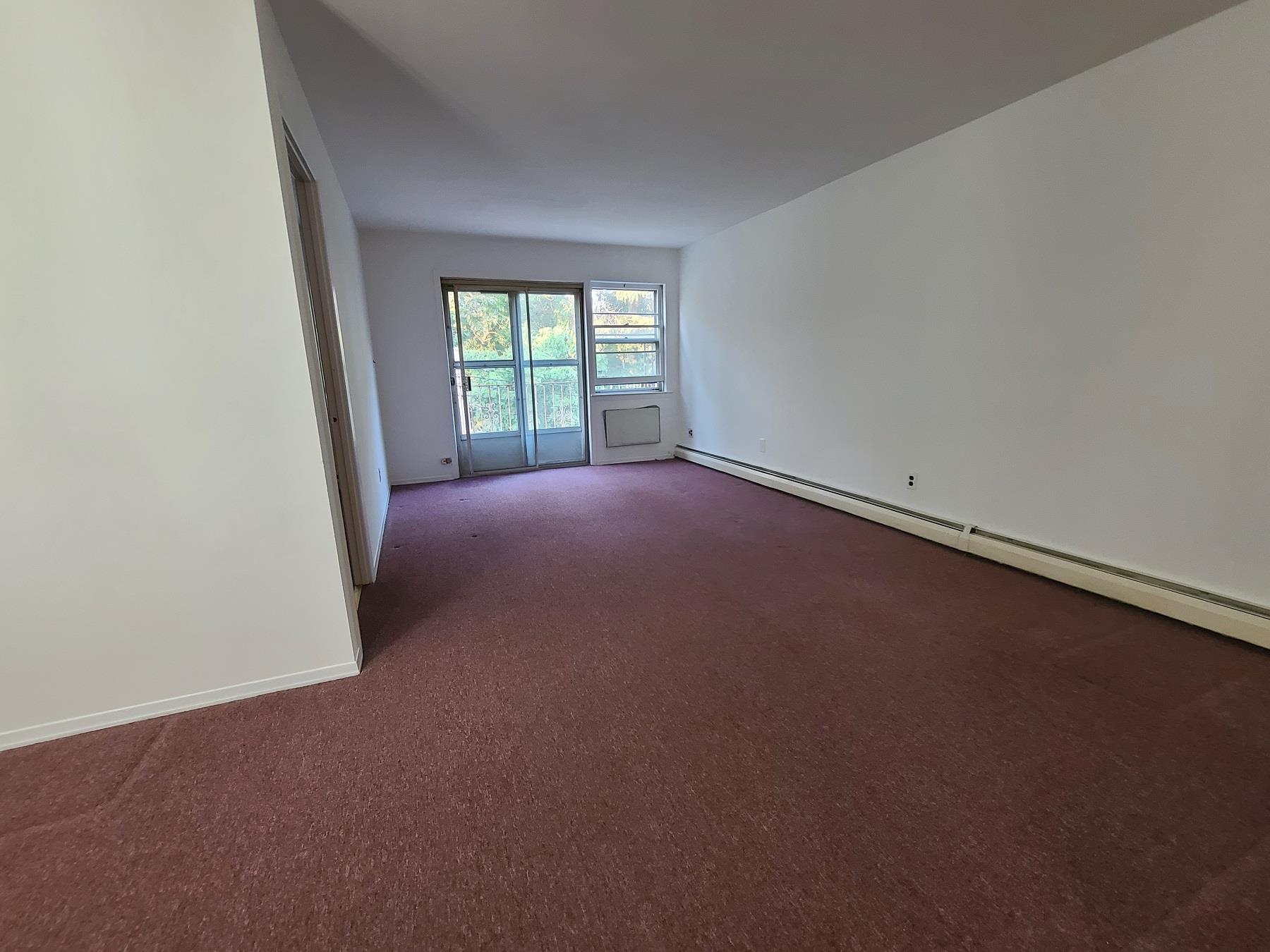 85-10 165th Street Queens, NY 11432 - Photo 19 of 24 an empty room with windows