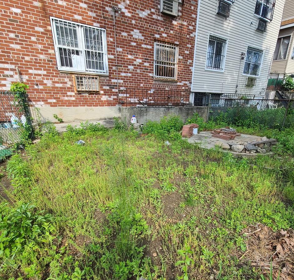 85-10 165th Street Queens, NY 11432 - Photo 5 of 24 a view of backyard of house with green space