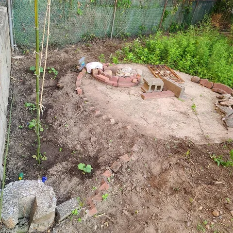 a view of a backyard with table and chairs and potted plants