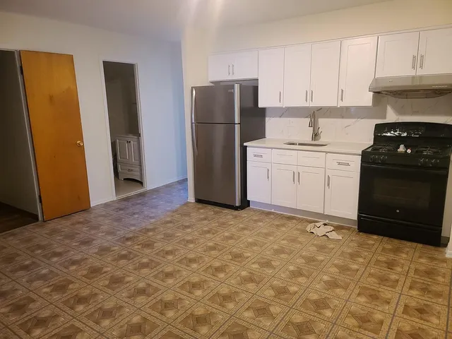 a kitchen with a refrigerator and a stove