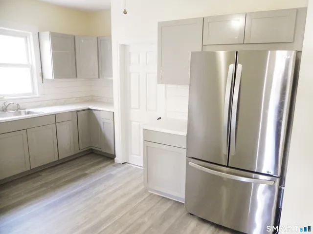 a white refrigerator freezer sitting inside of a kitchen