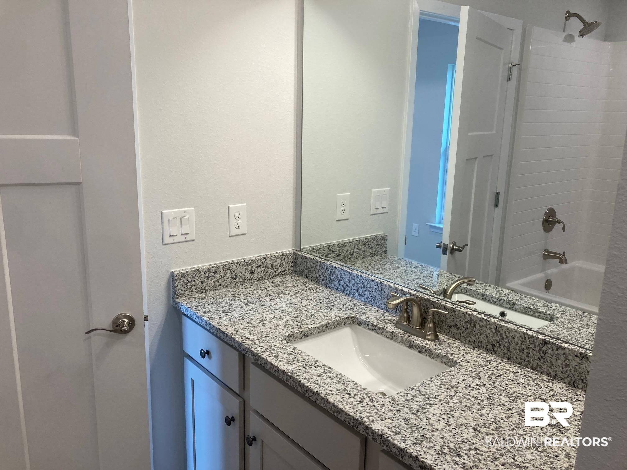 649 Revere Street Foley, AL 36535 - Photo 15 of 18 Bathroom featuring vanity and bathing tub / shower combination