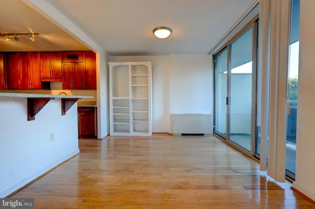 an empty room with windows and cabinet