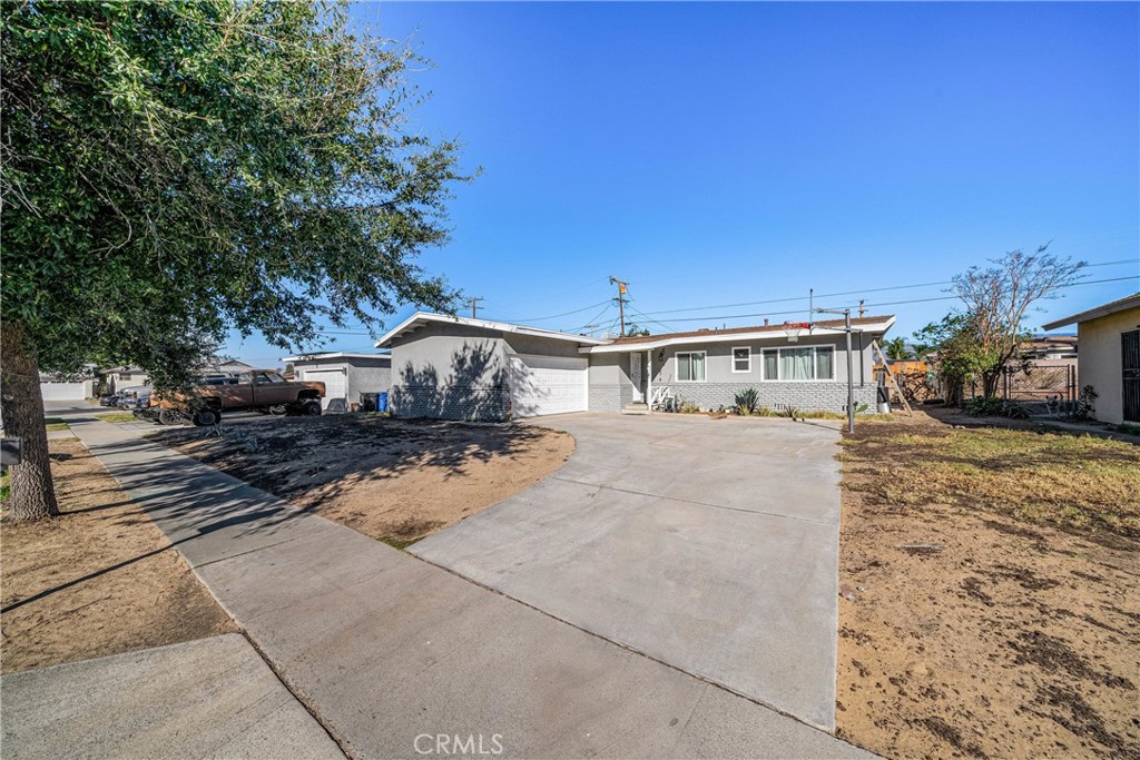 570 East Huff Street Rialto, CA 92376 - Photo 1 of 1 a front view of a house with a yard