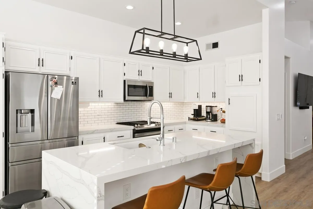 1461 Knoll Park Glen Escondido, CA 92029 - Photo 11 of 25 a kitchen with stainless steel appliances a sink a stove a refrigerator cabinets and chairs