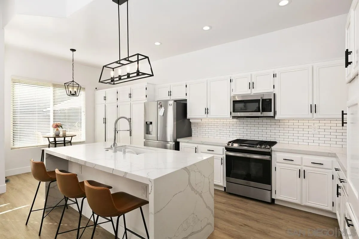 1461 Knoll Park Glen Escondido, CA 92029 - Photo 12 of 25 a kitchen with stainless steel appliances a stove sink microwave and cabinets
