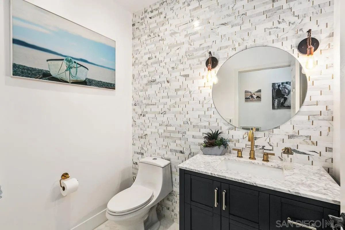 1461 Knoll Park Glen Escondido, CA 92029 - Photo 13 of 25 a bathroom with a granite countertop toilet sink and mirror