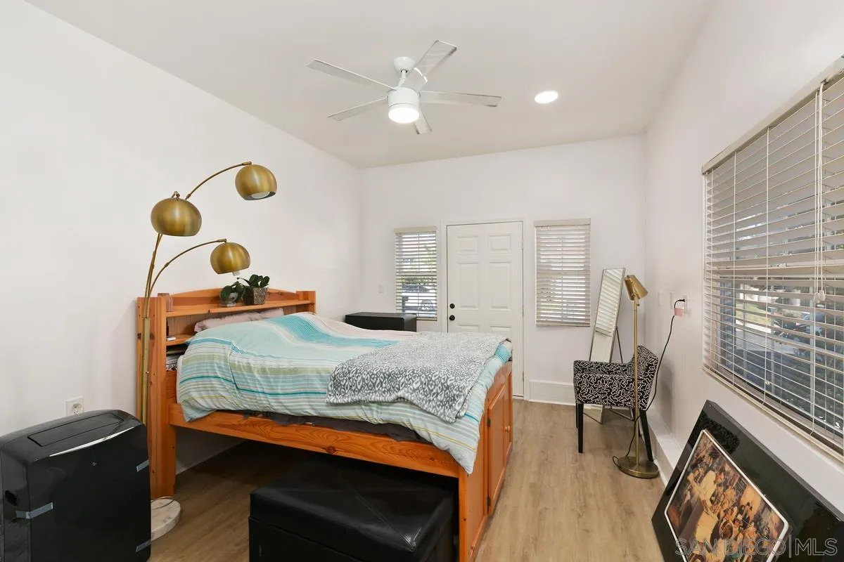 1461 Knoll Park Glen Escondido, CA 92029 - Photo 21 of 25 a bedroom with a bed and a chandelier