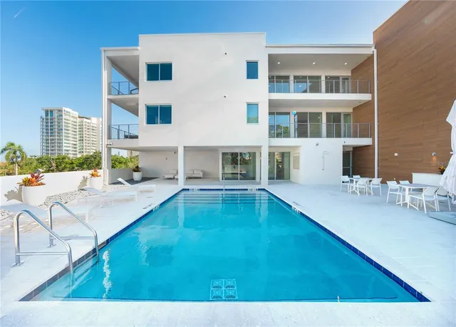 a swimming pool view with outdoor seating