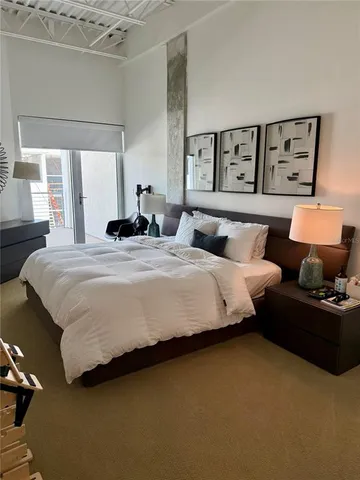 a bedroom with bed and window