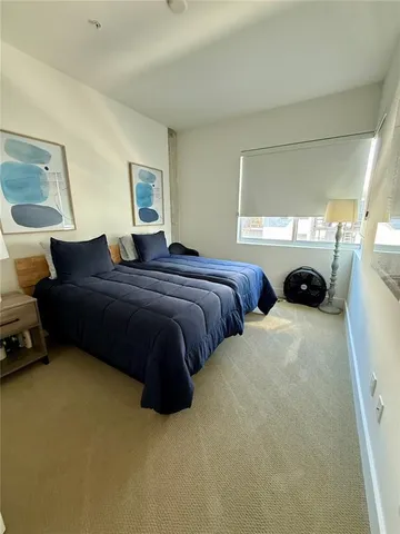 a bedroom with bed and window