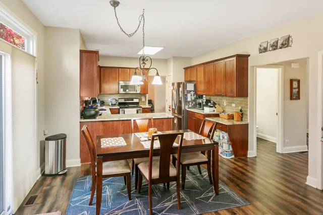 a dining room with furniture and wooden floor