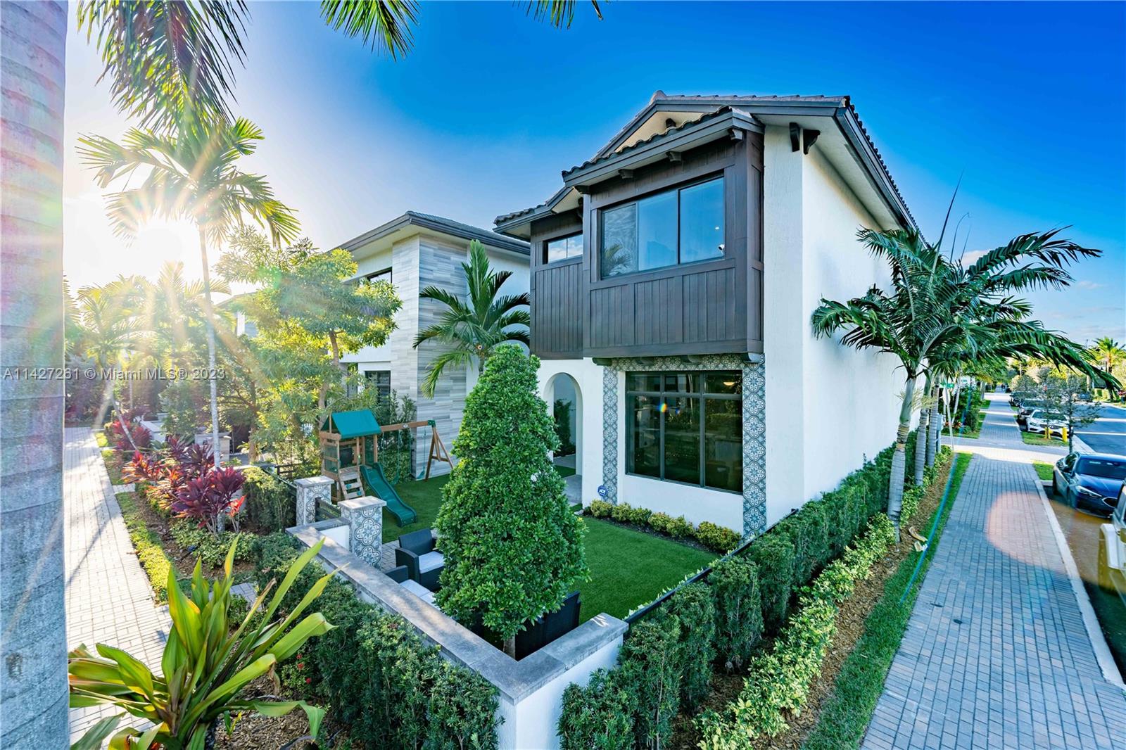 8210 Northwest 46th Street Doral, FL 33166 - Photo 1 of 59 a front view of a house with a yard