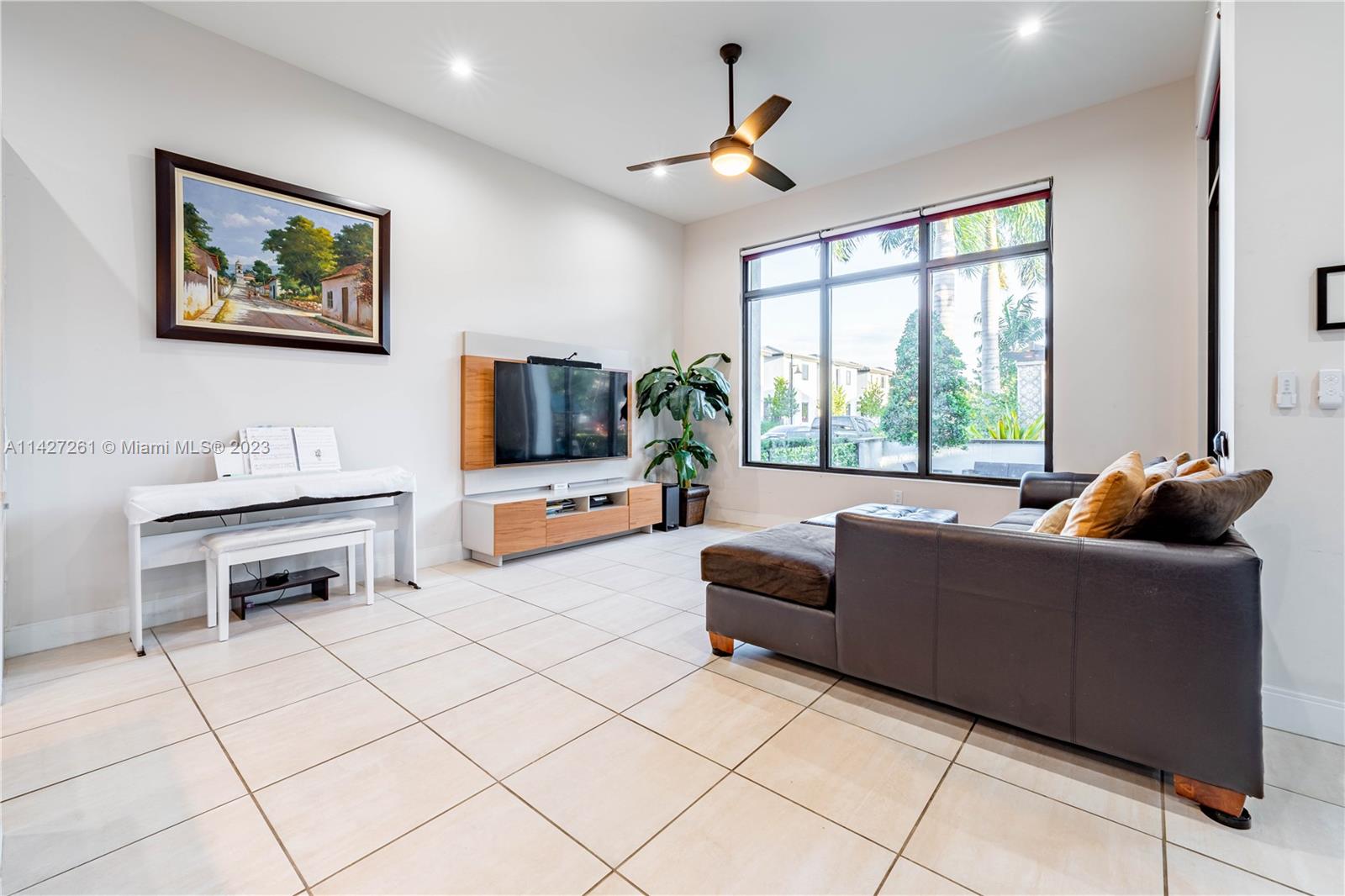 8210 Northwest 46th Street Doral, FL 33166 - Photo 14 of 59 a living room with furniture and a flat screen tv