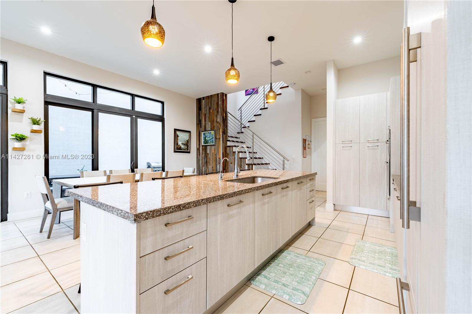 8210 Northwest 46th Street Doral, FL 33166 - Photo 19 of 59 a large white kitchen with a sink and chandelier