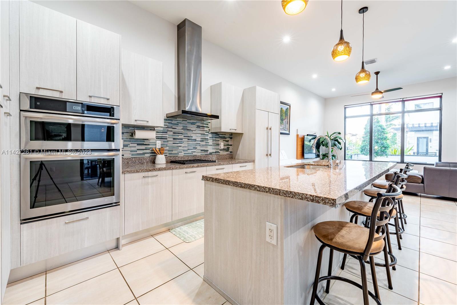8210 Northwest 46th Street Doral, FL 33166 - Photo 22 of 59 a kitchen with stainless steel appliances granite countertop a stove a sink and a microwave