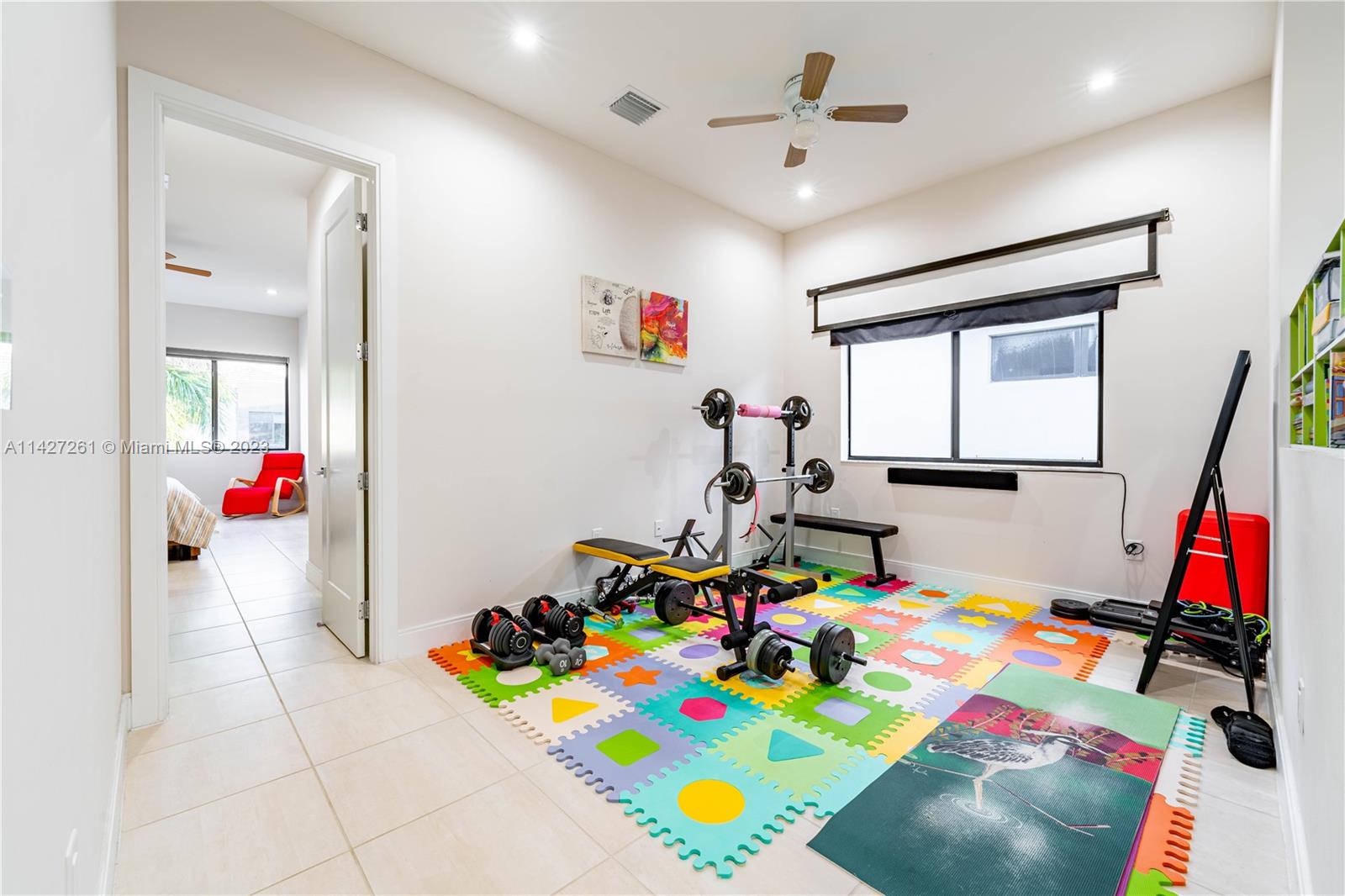 8210 Northwest 46th Street Doral, FL 33166 - Photo 27 of 59 a children room with furniture and a flat screen tv