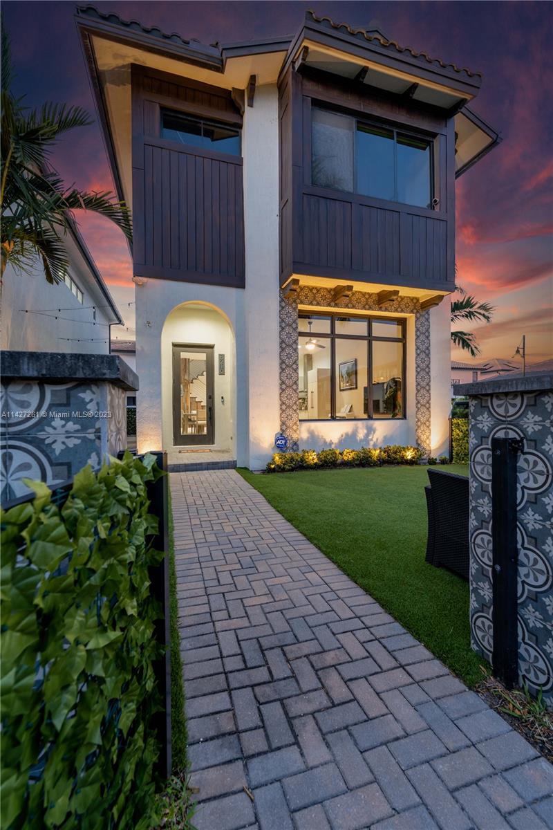 8210 Northwest 46th Street Doral, FL 33166 - Photo 3 of 59 a front view of a house with garden